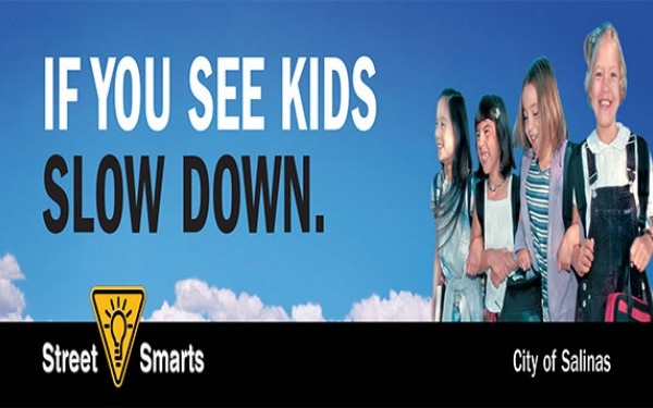 If You See Kids Slow Down, four children smiling, blue sky 