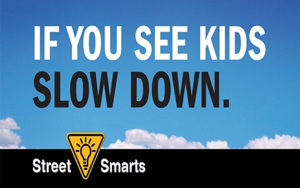 If You See Kids Slow Down, blue sky with clouds smart street